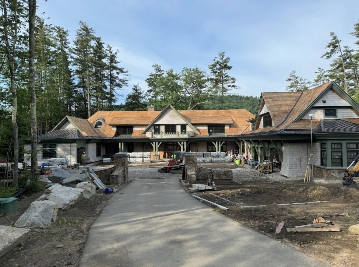 Custom shingle-style luxury estate exterior with cedar roof and green trim painted by Costa Painting Pro