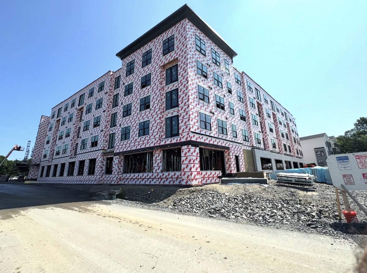 Multi-story apartment building under construction prepped for exterior painting by Costa Painting Pro