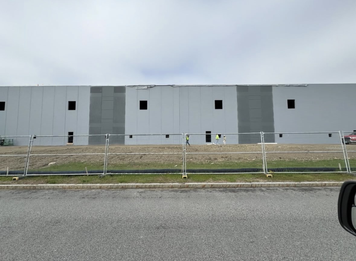 Industrial warehouse exterior with fresh light gray paint by Costa Painting Pro